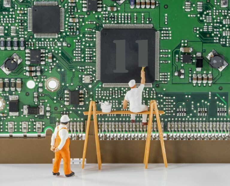 mini technicians painting 11 on cpu for mother board graphic getting ready for installing windows 11 features top 5