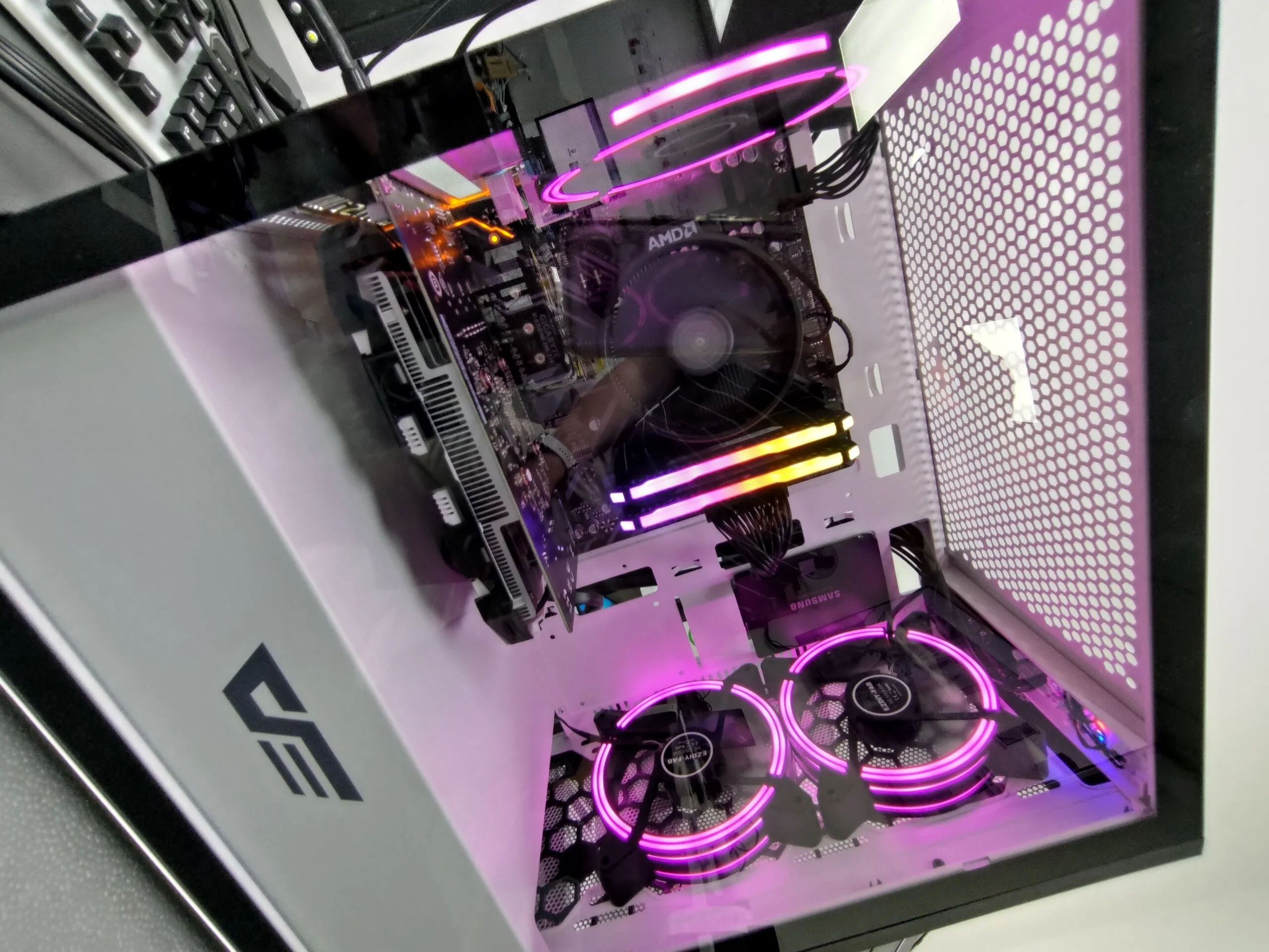 Custom gaming pc shot through the glass to see internals with purple rgb lights nice and clean running fast and working great after revival tech repair tuneup