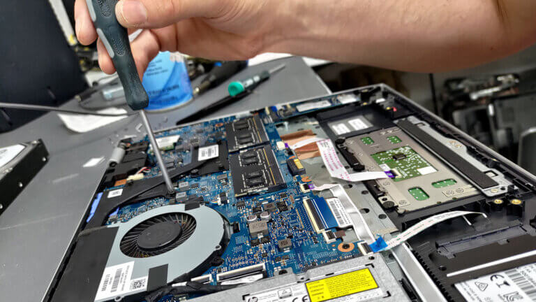 inside-shot-of-scott-working-on-dell-laptop-computer-repair-at-revival-tech-rockford-il-shop-fixing-broken-computer-with-clean-up-maintenane-1