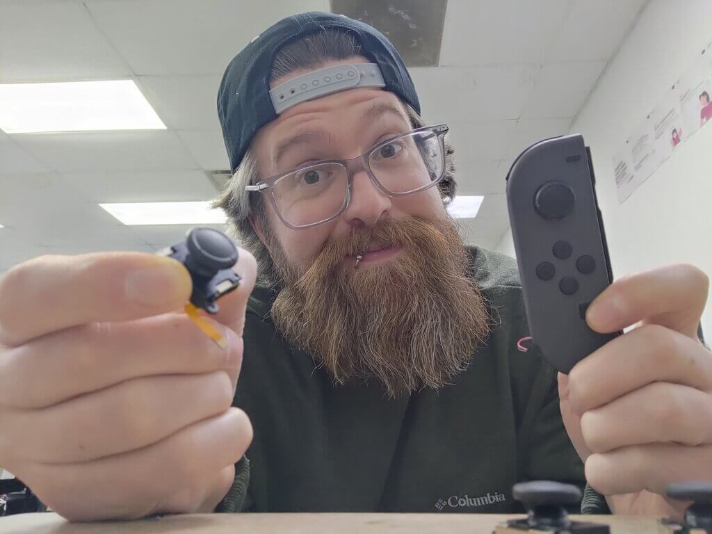 scott-holding-switch-joycon-controller-sitck-drift-repair-replace-tmr-hall-effect-joystick-in-joycon-1
